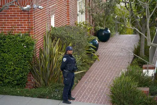 A police officer stands outside the home of House Speaker Nancy Pelosi and her husband Paul Pelosi in San Francisco, Friday, Oct. 28, 2022. Paul Pelosi, was attacked and severely beaten by an assailant with a hammer who broke into their San Francisco home early Friday, according to people familiar with the investigation. (AP Photo/Godofredo A. Vásquez)