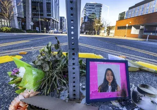A photo of Jaahnavi Kandula is displayed with flowers, Jan. 29, 2023 in Seattle. Prosecutors in Washington state said Wednesday, Feb. 21, 2024, they will not file felony charges against the Seattle police officer who struck and killed the graduate student from India while responding to an overdose call. (Ken Lambert/The Seattle Times via AP, File)