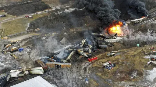 In this photo taken with a drone, portions of a Norfolk Southern freight train that derailed the previous night in East Palestine, Ohio, remain on fire at mid-day, Feb. 4, 2023. The Pipelines and Hazardous Materials Safety Administration proposed a new rule Wednesday, June 21, that would require all railroads to quickly provide the details of everything aboard their trains electronically to every emergency responder within 10 miles of a derailment. (AP Photo/Gene J. Puskar, File)
