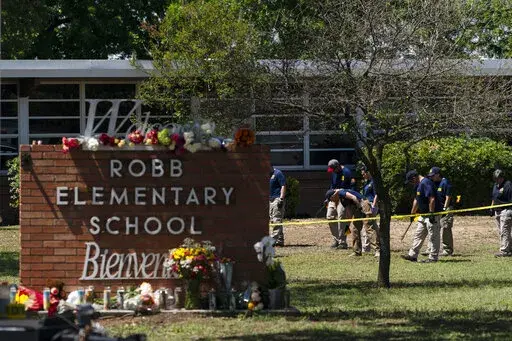 Investigators search for evidences outside Robb Elementary School in Uvalde, Texas, May 25, 2022. The children who survived the attack, which killed 19 schoolchildren and two teachers, described a festive, end-of-the-school-year day that quickly turned to terror. (AP Photo/Jae C. Hong, File)