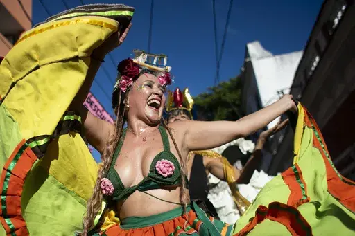 A reveler performs on stilts during the "Ceu na Terra" or "Heaven on Earth" Carnival street party in Rio de Janeiro, Saturday, March 1, 2025. (AP Photo/Bruna Prado)