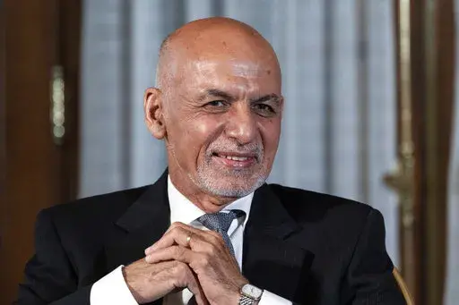 FILE - Afghan President Ashraf Ghani is seated after his meeting with U.S. President Joe Biden in Washington, June 25, 2021. In an interview aired by the BBC on Thursday, Dec. 30, 2021, Afghanistan's former president recounts his final hours in office, says he had just minutes to decide to flee and denies an agreement was in the works for a peaceful takeover, disputing accounts of former government officials, Taliban and even a former U.S. negotiator. (AP Photo/Alex Brandon, File)