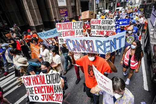 Housing activists march across town toward New York Gov. Kathy Hochul's office, calling for an extension of pandemic-era eviction protections, Tuesday, Aug. 31, 2021, in New York. Prices paid by U.S. consumers jumped in December 2021 compared to a year earlier, the latest evidence that rising costs for food, gas, rent and other necessities are heightening the financial pressures on America's households. (AP Photo/Mary Altaffer, File)