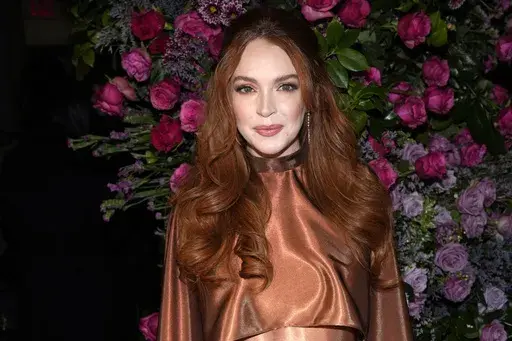 Actress Lindsay Lohan appears at the Christian Siriano Fall/Winter 2023 fashion show in New York, Feb. 9, 2023. The Securities and Exchange Commission said Wednesday, March 22, that Lohan, rapper Akon and several other celebrities have agreed to pay tens of thousands of dollars to settle claims that they promoted crypto investments to their millions of social media followers without disclosing they were being paid to do so. (Photo by Charles Sykes/Invision/AP, File)