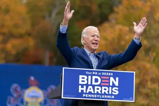 Democratic presidential candidate former Vice President Joe Biden speaks at a drive-in campaign stop at Bucks County Community College in Bristol, Pa., Oct. 24, 2020. Biden and his allies hope big recent wins on climate, health care and more will at least temporarily tamp down questions among top Democrats about whether he will run for reelection. (AP Photo/Andrew Harnik, File)