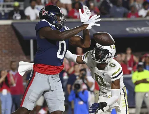 Mississippi tight end Michael Trigg, left, drops a pass under pressure from Georgia Tech defensive back Myles Sims during the first half an NCAA college football game in Oxford, Miss., Saturday, Sept. 16, 2023. (AP Photo/Thomas Graning)