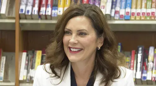 In this image made from video, Michigan Gov. Gretchen Whitmer speaks with educators, parents and students during a back-to-school event at Novi High School on Wednesday, Aug. 24, 2022, in Novi, Mich. A day earlier, two men were convicted of conspiring to kidnap Whitmer. (AP Photo/Mike Householder)