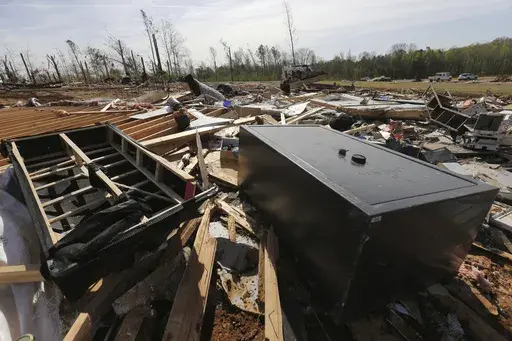 A gun vault and broken debris is all that is left of the home of Chad Mills along Hwy 15, Saturday, April 1, 2023 in Pontotoc, Miss. Storms that dropped possibly dozens of tornadoes killed multiple people in small towns and big cities across the South and Midwest, tearing a path through the Arkansas capital, collapsing the roof of a packed concert venue in Illinois, and stunning people throughout the region Saturday with the damage's scope.(Thomas Wells/The Northeast Mississippi Daily Journal vi