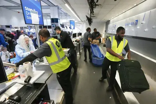 Passenger drop off their baggage at United Airlines in C Terminal at George Bush Intercontinental Airport, Thursday, Dec. 21, 2023, in Houston. The Biden administration issued final rules Wednesday, April 24, 2024, to require airlines to automatically issue cash refunds for things like delayed flights and to better disclose fees for baggage or canceling a reservation. (Brett Coomer/Houston Chronicle via AP, File)