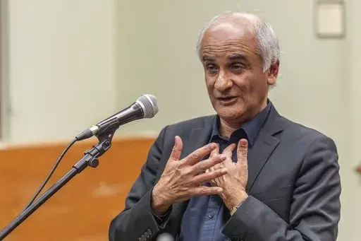 Pico Iyer, the bestselling author of "The Art of Stillness," presents his new book "Aflame: Learning from Silence" at Vroman's bookstore in Pasadena, Calif., on Tuesday, Jan. 28, 2025, in the wake of the devastating Eaton Fire that recently swept through parts of Pasadena and Altadena, forcing over 30,000 people to evacuate and burning thousands of structures. (AP Photo/Damian Dovarganes)