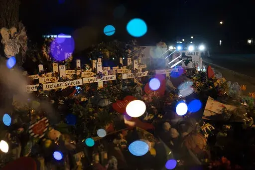 Crosses bearing the names of the victims killed in the school shooting are seen through a balloon at a memorial at Robb Elementary School in Uvalde, Texas, on June 1, 2022. (AP Photo/Jae C. Hong, File)