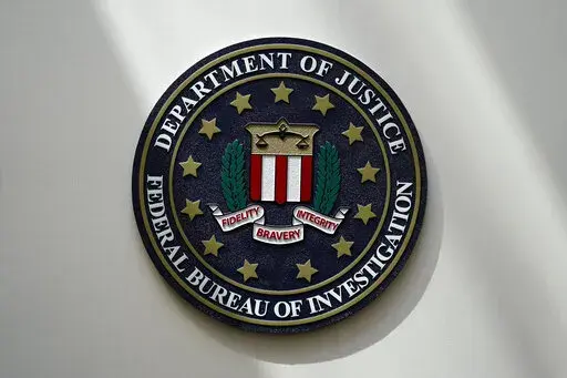 The FBI seal is pictured in Omaha, Neb., Aug. 10, 2022. The FBI is searching for a Florida woman who was supposed to stand trial Monday, March 6, 2023, on charges stemming from the Jan. 6, 2021, Capitol attack as well as another riot defendant who has gone missing. An FBI agent said Monday that a federal judge in Washington issued bench warrants for the arrest of Olivia Pollock and Joseph Hutchinson III last week after the court was notified that they had tampered with or removed the ankle monit
