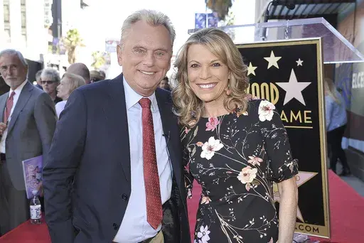 Pat Sajak, left, and Vanna White, from "Wheel of Fortune," attend a ceremony honoring Harry Friedman with a star on the Hollywood Walk of Fame in Los Angeles on Nov. 1, 2019. (Photo by Richard Shotwell/Invision/AP, File)