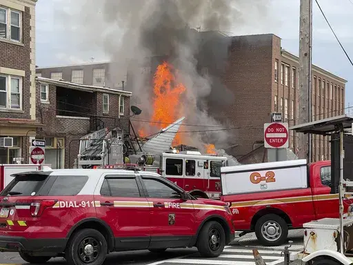 Emergency personnel work at the site of a deadly explosion at a chocolate factory in West Reading, Pa., March 25, 2023. Natural gas leaked from a defective fitting at the Pennsylvania chocolate factory where a powerful explosion leveled one building, heavily damaged another and killed seven people, federal safety investigators said on Tuesday, July 18, as they sought to pinpoint a cause. (Ben Hasty/Reading Eagle via AP, File)