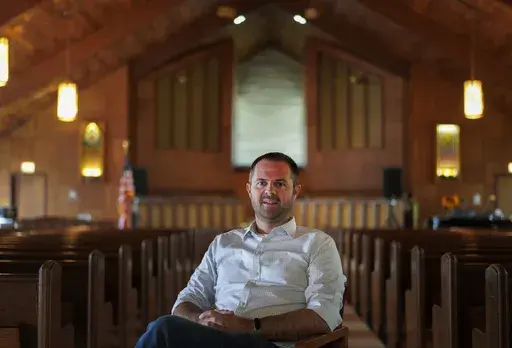 Pastor Ryan Burge, an associate professor of political science at Eastern Illinois University and author of "The Nones," poses for a portrait at at First Baptist Church in Mt. Vernon, Ill., Sept. 10, 2023. (AP Photo/Jessie Wardarski, File)
