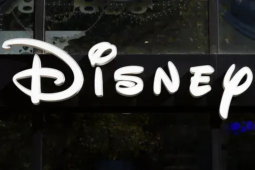 This Sept. 20, 2017, file photo shows a sign at the Disney store on the Champs Elysees Avenue in Paris, France.  The Supreme Court’s decision to end the nation’s constitutional protections for abortion has catapulted businesses of all types into the most divisive corner of politics. A rash of iconic names including The Walt Disney Company, Facebook parent Meta, and Goldman Sachs announced they would pay for travel expenses for those who want the procedure but can't get it in the states they 