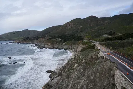 The collapsed section of the southbound lane of Highway 1 at Rocky Creek Bridge is marked off by cones Thursday, April 4, 2024, in Big Sur, Calif. The break has caused the closure of the scenic road. (AP Photo/Godofredo A. Vásquez)
