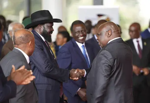 South Sudanese President Salva Kiir Mayardit, left, shakes hands with Pagan Amum Okiech, leader of the Real-SPLM group, during the launch of high-level peace talks for South Sudan at State House in Nairobi, Kenya, on Thursday, May 9, 2024. South Sudan peace talks that almost reached completion faced a stumbling block with opposition groups demanding a newly passed bill allowing the detention of people without an arrest warrant scratched out in order to sign a proposed agreement. (AP Photo/Brian 