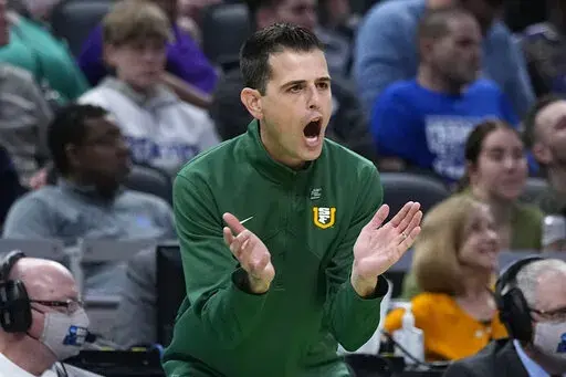 San Francisco head coach Todd Golden applauds his team during the first half of a college basketball game against Murray State in the first round of the NCAA tournament, Thursday, March 17, 2022, in Indianapolis. (AP Photo/Darron Cummings)