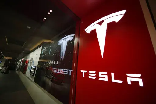 A sign bearing the company logo is displayed outside a Tesla store in Cherry Creek Mall in Denver. More than 750 Tesla owners have complained to U.S. safety regulators that cars operating on the automaker's partially automated driving systems have suddenly stopped on roadways for no apparent reason. The National Highway Traffic Safety Administration revealed the number in a detailed information request letter to Tesla that was posted Friday, June 3, 2022, on the agency's website.
(AP Photo/Davi