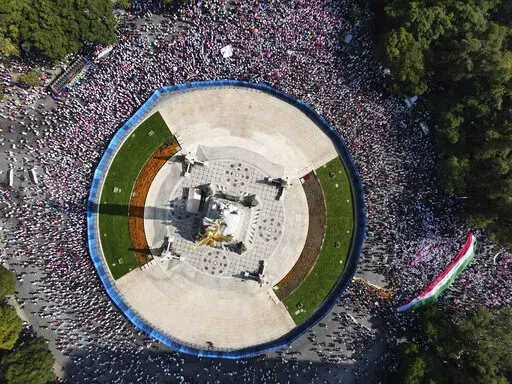 Citizen organizations rally at Mexico City's iconic "Angel of Independence" monument in support of Mexico's National Elections Institute as President Andrés Manuel Lopez Obrador pushes to overhaul it, Sunday, Nov. 13, 2022. (AP Photo/Marco Ugarte)