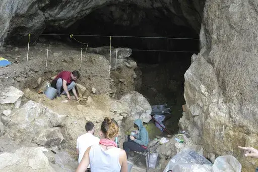 In this photo provided by Bence Viola in October 2022, researchers excavate a cave in the mountains of Siberia, Russia. In a study published Wednesday, Oct. 19, 2022, in the journal Nature, researchers were able to pull DNA out of tiny bone fragments found in two Russian caves, and used the genetic data to map out relationships between 13 different Neanderthals for clues to how they lived. (Bence Viola via AP)