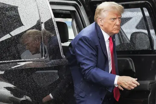Former President Donald Trump arrives to board his plane at Ronald Reagan Washington National Airport, Aug. 3, 2023, in Arlington, Va., after facing a judge on federal conspiracy charges that allege he conspired to subvert the 2020 election. Trump and his legal team face long odds in their bid to move his 2020 election conspiracy trial out of Washington. They argue the Republican former president can’t possibly get a fair trial in the overwhelmingly Democratic nation’s capital. (AP Photo/Ale