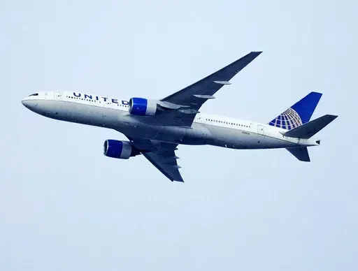 A United Airlines jetliner soars past an MLS soccer match July 8, 2023, in Commerce City, Colo. United Airlines and the union representing its pilots said Saturday, July 15, 2023, they reached agreement on a contract that will raise pilot pay by up to 40% over four years. (AP Photo/David Zalubowski, File)