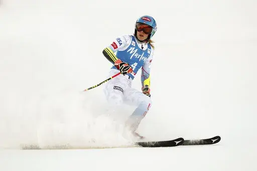 United States' Mikaela Shiffrin checks her time at the finish area of an alpine ski, women's World Cup giant slalom, in Kronplatz, Italy, Jan. 25, 2022. Empathizing with other athletes’ frank conversations about mental health got Shiffrin thinking about what awaits her at the Beijing Olympics. (AP Photo/Gabriele Facciotti, File)