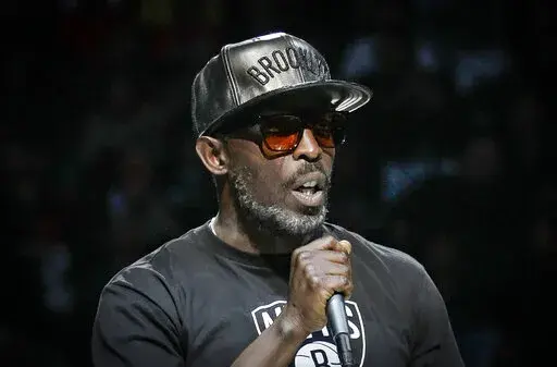 Actor Michael K. Williams introduces the Brooklyn Nets starting lineup during NBA basketball first-round playoffs Friday, April 25, 2014, in New York. A federal prosecutor said Wednesday, Feb. 2, 2022, four men have been charged in the overdose death of Williams, who gained fame playing Omar Little on "The Wire." (AP Photo/Frank Franklin II, File)