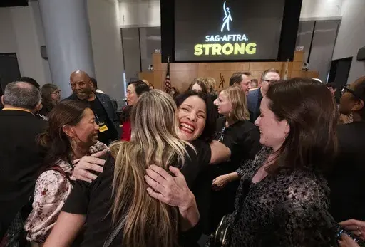 SAG-AFTRA President Fran Drescher, hugs a member of the TV/Theatrical Negotiating Committee member in celebration after a news conference at the SAG-AFTRA offices in Los Angeles on Friday, Nov. 10, 2023. (AP Photo/Richard Vogel)