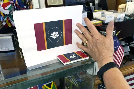 Mississippi Gov. Tate Reeves announced on Tuesday, May 2, 2023, that the state is getting a new standard license plate in January 2024 that features the magnolia also seen on the state flag. The flag is shown at A Complete Flag Source in Jackson, Miss., Oct. 27, 2020. (AP Photo/Rogelio V. Solis, File)