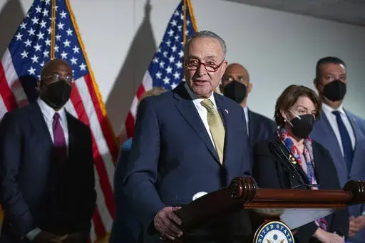 Senate Majority Leader Chuck Schumer, D-N.Y., speaks to reporters alongside, from left, Sen. Raphael Warnock, D-Ga., Sen. Cory Booker, D-N.J., Sen. Amy Klobuchar, D-Minn., and Sen. Alex Padilla, D-Calif., during a press conference regarding the Democratic party's shift to focus on voting rights at the Capitol in Washington, Tuesday, Jan. 18, 2022. (AP Photo/Amanda Andrade-Rhoades)
