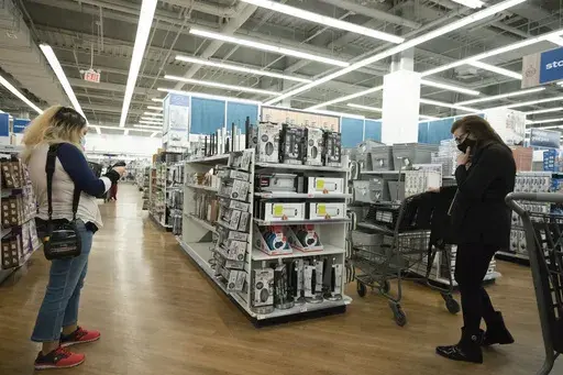 In this March 25, 2021 file photo, shoppers browse in New York. Women often pay more for goods and services, but it doesn’t have to be that way. Shopping experts say that by opting for gender-neutral personal care products, consumers can sometimes avoid what’s been dubbed the “pink tax.” (AP Photo/Mark Lennihan, File)