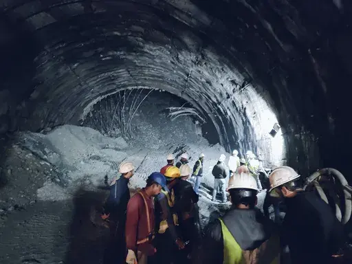This photo provided by Uttarakhand State Disaster Response Force (SDRF) shows rescuers inside a collapsed road tunnel where more than 30 workers were trapped by a landslide in northern in Uttarakhand state, India, Sunday, Nov.12, 2023. ( SDRF via AP)