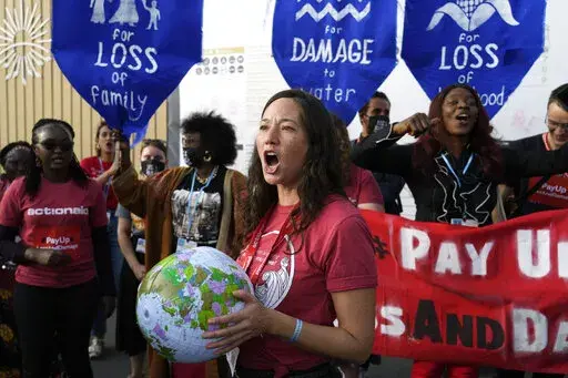 Activist Teresa Anderson participates in a protest demanding pay for loss and damage at the COP27 U.N. Climate Summit, Wednesday, Nov. 16, 2022, in Sharm el-Sheikh, Egypt. (AP Photo/Peter Dejong)