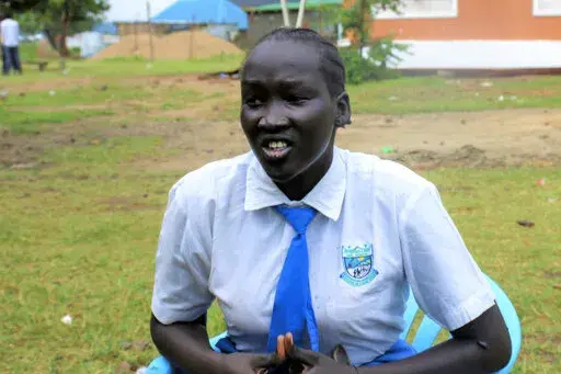 Nyanachiek Madit, 21, who successfully refused when her father told her at age 17 that she would be married off to a man about 50 years old because her family couldn't afford to send her to school, speaks to The Associated Press in Juba, South Sudan on Wednesday, June 8, 2022. Some young girls are auctioned off into marriage for cows in South Sudan - a practice that the government and international organizations are fighting to promote better health and educational opportunities. (AP Photo/Deng 