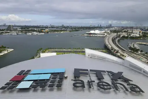 In this photo taken with a drone, the FTX logo is seen on the roof of the FTX Arena on Wednesday, Dec. 7, 2022, in Miami. The House Financial Services Committee holds a hearing on Tuesday on the collapse of cryptocurrency exchange FTX. (AP Photo/Rebecca Blackwell)