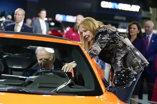 Mary Barra, CEO of General Motors, talks with President Joe Biden as he sits in a Corvette during a tour of the Detroit Auto Show on Sept. 14, 2022, in Detroit. United Auto Workers President Shawn Fain's focus on CEO pay is part of a growing trend as emboldened labor unions cite the widening wealth gap between workers and the top bosses to bolster their demand for higher wages and better working conditions. (AP Photo/Evan Vucci, File)