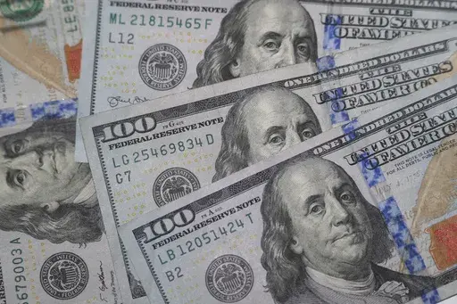 This Jan. 22, 2020, file photo shows the likeness of Benjamin Franklin on $100 bills in Dallas. Realizing that financial stress is common can be the first step toward reducing it, money experts say. Thinking you are the only one experiencing it can compound those negative feelings. Checking in with your body, so you notice when you’re having a fight-or-flight response to financial decisions, can also help. (AP Photo/LM Otero, File)