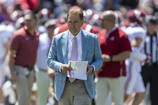 Alabama head coach Nick Saban paces as his team warms up before Alabama's A-Day NCAA college football scrimmage, Saturday, April 22, 2023, in Tuscaloosa, Ala. Saban says college football is not a business that operates like the NFL and warned that without more uniform rules on player compensation only the biggest spenders will compete for championships. (AP Photo/Vasha Hunt, File)