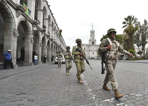 Soldiers patrol in Arequipa, Peru, Wednesday, Dec. 14, 2022. Peru’s new government declared a 30-day national emergency on Wednesday amid violent protests following the ouster of President Pedro Castillo, suspending the rights of “personal security and freedom” across the Andean nation. (AP Photo/Jose Sotomayor)