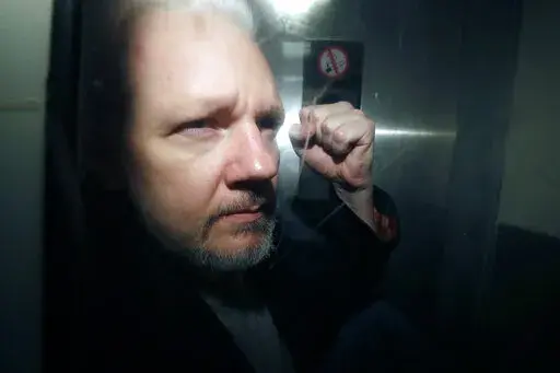 WikiLeaks founder Julian Assange being taken from court, where he appeared on charges of jumping British bail seven years ago, in London, Wednesday May 1, 2019. Britain's High Court is set to rule on whether WikiLeaks founder Julian Assange can take his fight against U.S. extradition to the U.K. Supreme Court. The decision is the latest step in Assange's long battle to avoid being sent to the United States to face espionage charges over WikiLeaks' publication of classified documents. (AP Photo/M