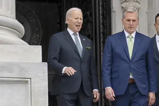 President Joe Biden talks with House Speaker Kevin McCarthy, R-Calif., as he departs the Capitol following the annual St. Patrick's Day gathering, in Washington, March 17, 2023. Facing the risk of a federal government default as soon as June 1, President Joe Biden has invited the top four congressional leaders to a White House meeting on May 9 for talks. It’s the first concrete step toward negotiations on averting a potential economic catastrophe, but there’s a long way to go: Biden and Repu