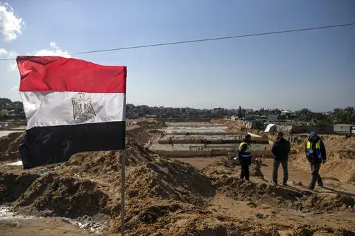Laborers work on concrete slab foundations for one of three Egyptian-funded housing complexes in the Gaza Strip, in the town of Beit Lahiya, northern Gaza, Tuesday, Jan. 25, 2022. After years of working behind the scenes as a mediator, Egypt is taking on a much larger and more public role in Gaza. In the months since it brokered a Gaza cease-fire last May, Egypt has sent crews to clear rubbled and promised to build vast new apartment complexes, and billboards of its president Abdel-Fattah el-Sis