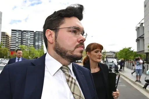 Former Liberal Party staff member Bruce Lehrmann arrives at the Australian Capital Territory Supreme Court in Canberra, Thursday, Oct. 27, 2022. A judge on Thursday discharged a jury in the high-profile trial of Lehrmann, a former government advisor, charged with raping a colleague in the Australian Parliament House because a juror had brought a research paper on sexual assaults into the jury room. (Mick Tsikas/AAP Image via AP)