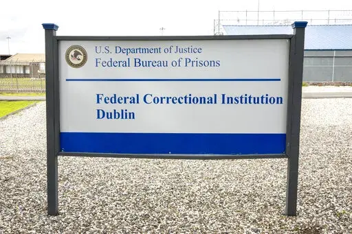 A sign for the Federal Correctional Institution Dublin is displayed on Jan. 9, 2019, in Dublin, Calif. A government watchdog has found a “substantial likelihood” the federal Bureau of Prisons committed wrongdoing when it ignored complaints and failed to address asbestos and mold contamination at the federal women’s prison that has already been under scrutiny for rampant sexual abuse of inmates. (Santiago Mejia/San Francisco Chronicle via AP, File)