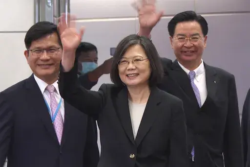 In this image made from video, Taiwan's Presidential office secretary general Lin Chia-lung, left, President Tsai Ing-wen, center, and Foreign Minister Joseph Wu wave before Tsai's departure on an overseas trip at Taoyuan International Airport in Taipei, Taiwan, Wednesday, March 29, 2023. China has threatened "resolute countermeasures" over a planned meeting between Taiwanese President Tsai Ing-wen and Speaker of the United States House Speaker Kevin McCarthy during an upcoming visit in Los Ange