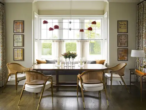 This image provided by Mendelson Group shows designer Gideon Mendelson's home in Sagaponack, New York. Mendelson framed some inexpensive yet eye-catching vintage deli signs for a playful element to the dining room. "Slow decorating" embraces a more deliberate approach that prioritizes a personal connection to the stuff we live with. (Eric Piasecki/OTTO via AP)