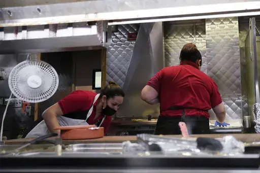 Women work in a restaurant kitchen in Chicago, Thursday, March 23, 2023. On Friday, the U.S. government issues the May jobs report. The labor market has added jobs at a steady clip in the past year, despite efforts by the Federal Reserve to cool the economy and bring down inflation. (AP Photo/Nam Y. Huh, File)